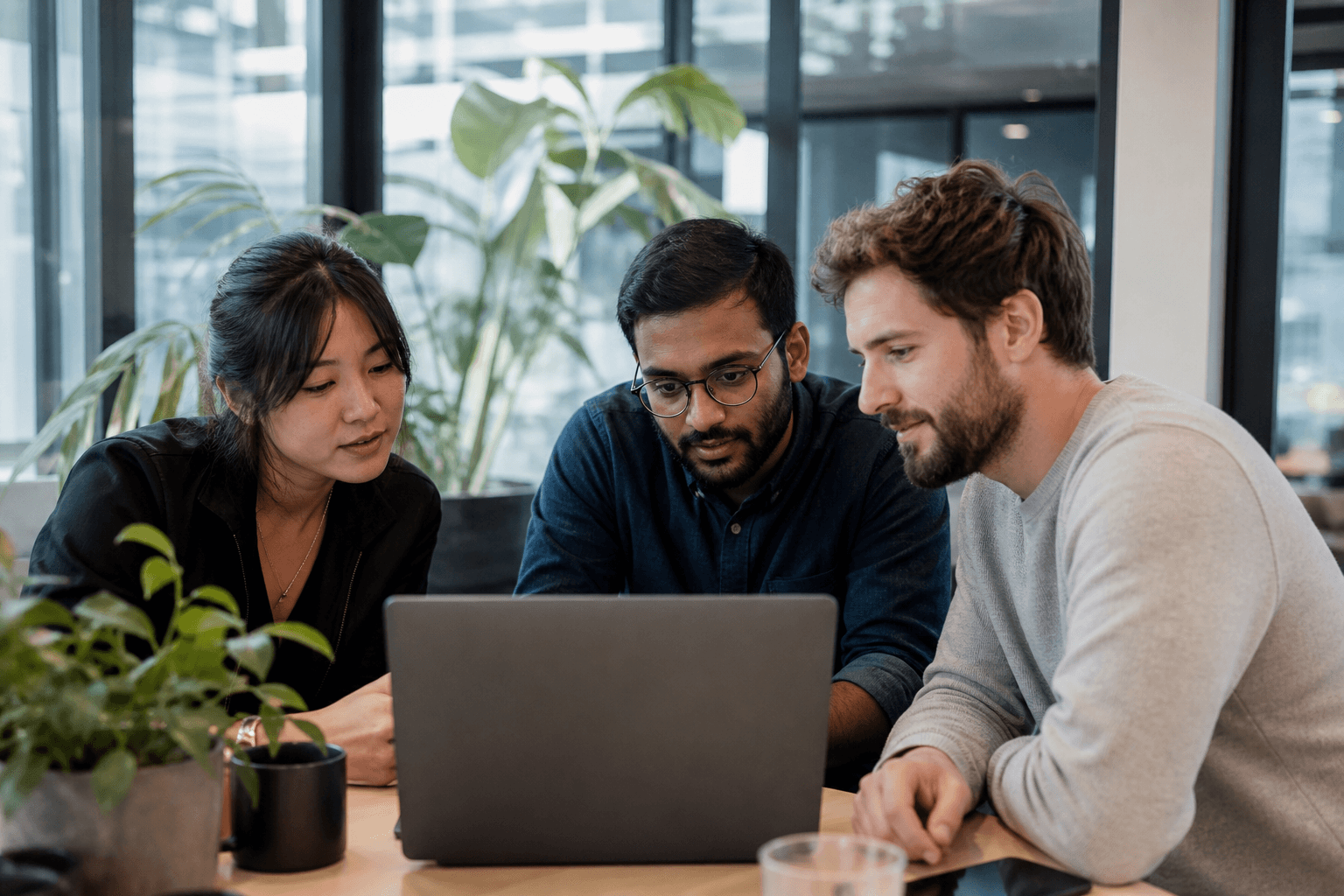 Engineers reviewing a build in a glass meeting room